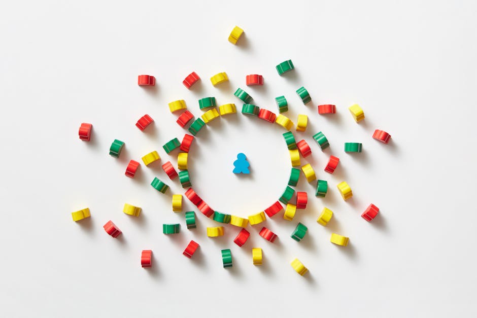 Abstract composition featuring a single blue pawn surrounded by colorful circular pieces on a white background.